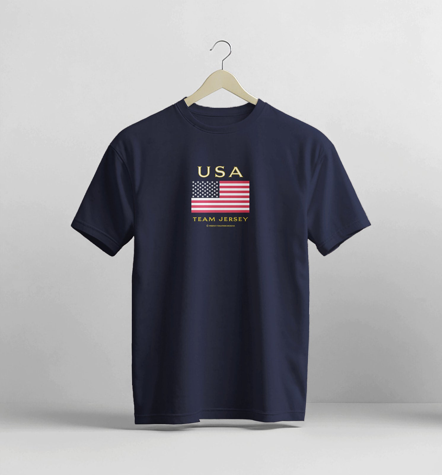 Navy blue t-shirt with USA flag design on a hanger against a light gray background