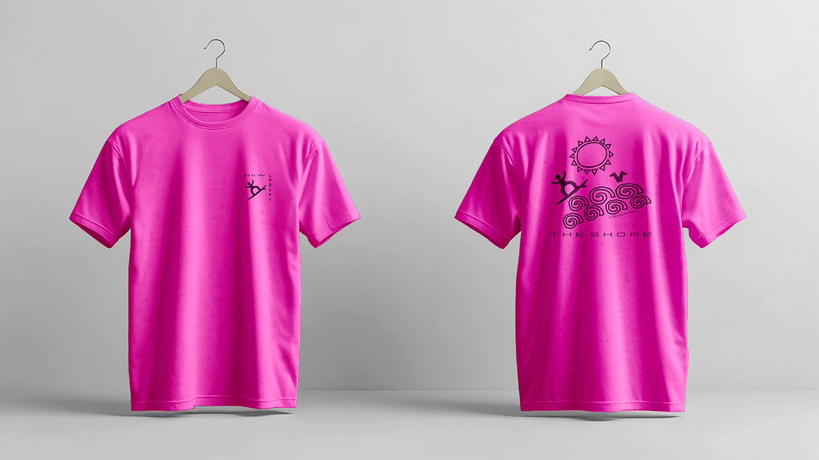 Pink t-shirt with designs on a gray background