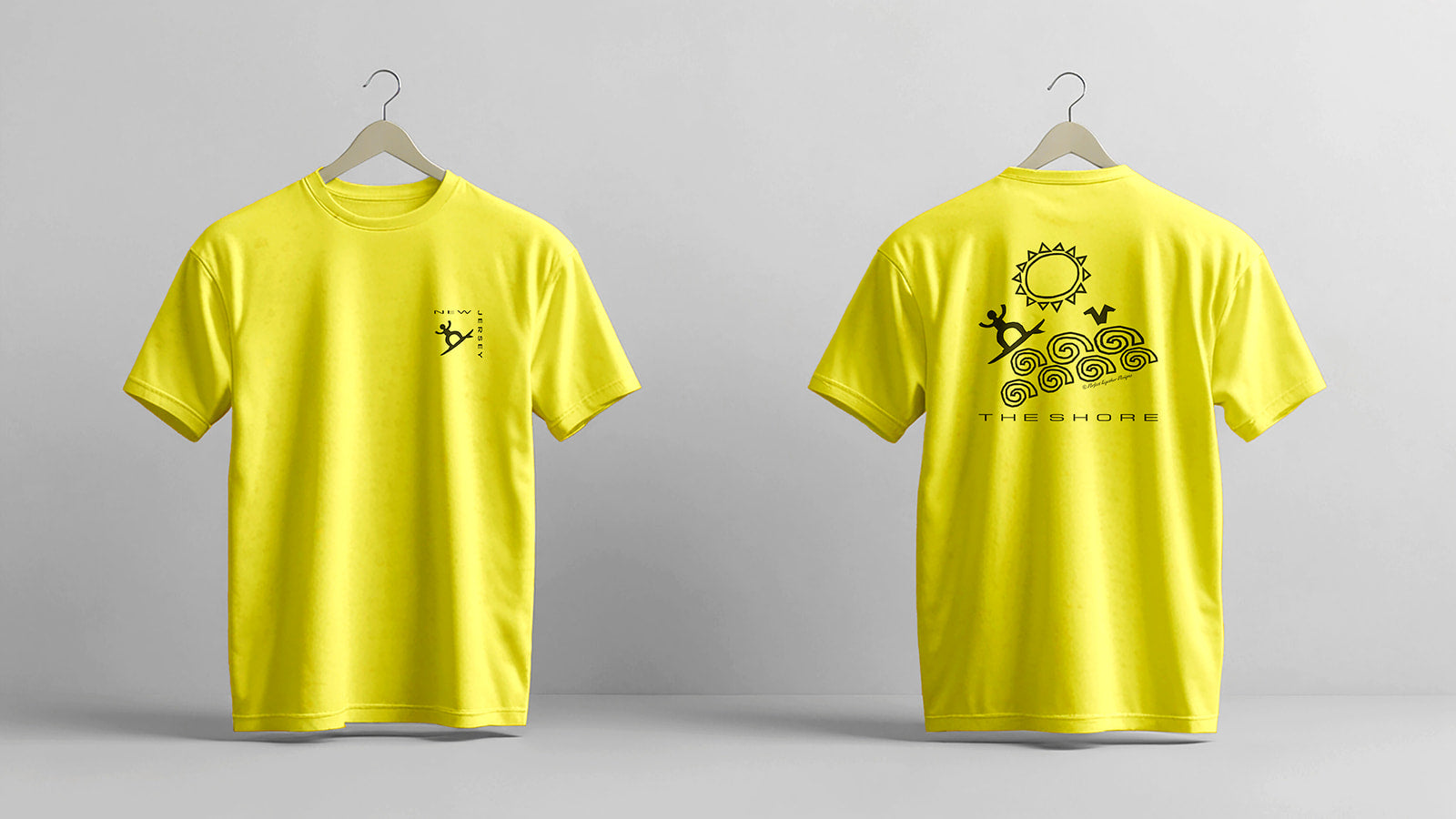 Yellow t-shirt with a logo on the front and text on the back, displayed on hangers against a gray background.