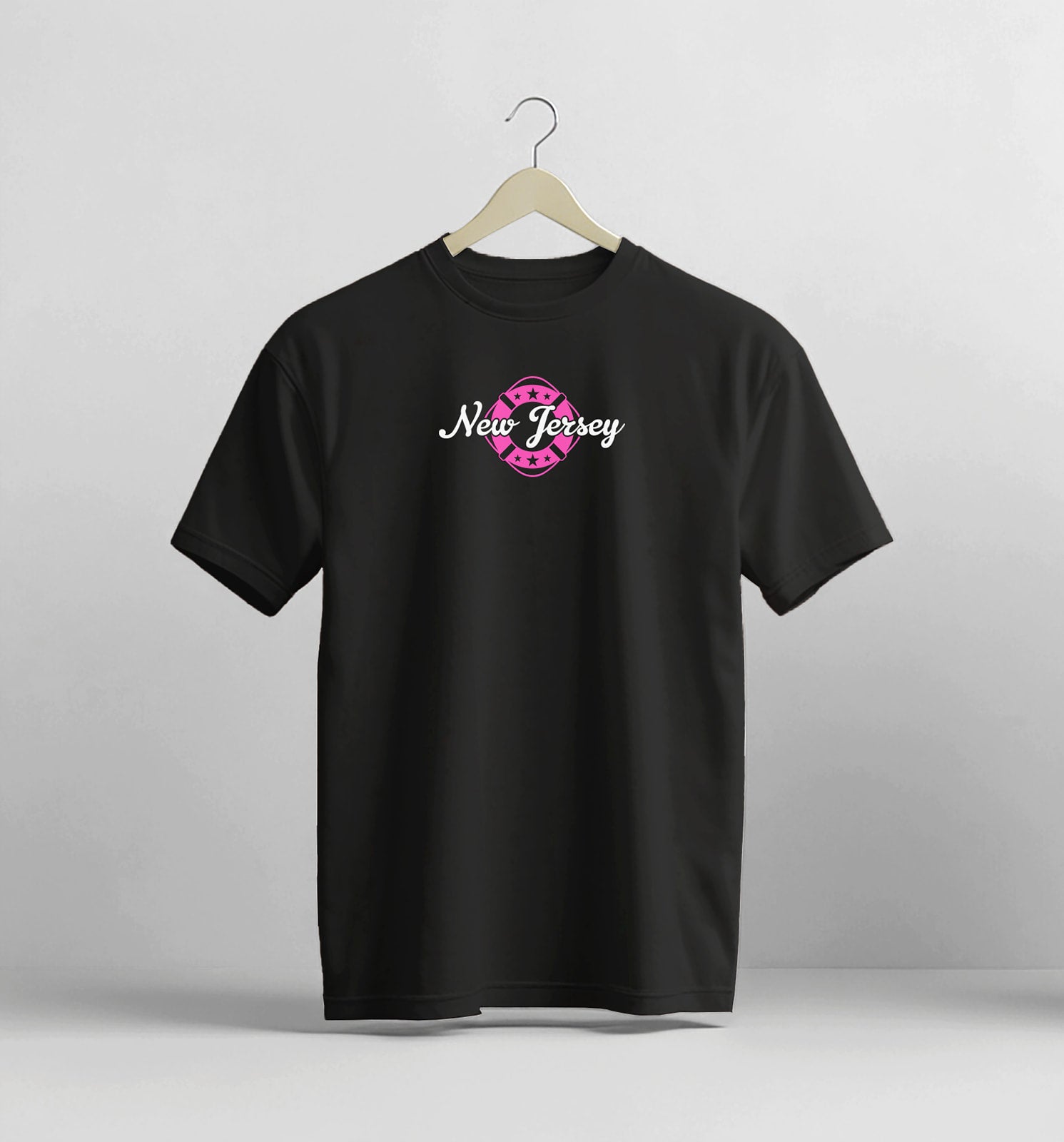 Black t-shirt with 'New Jersey' design on a hanger against a gray background
