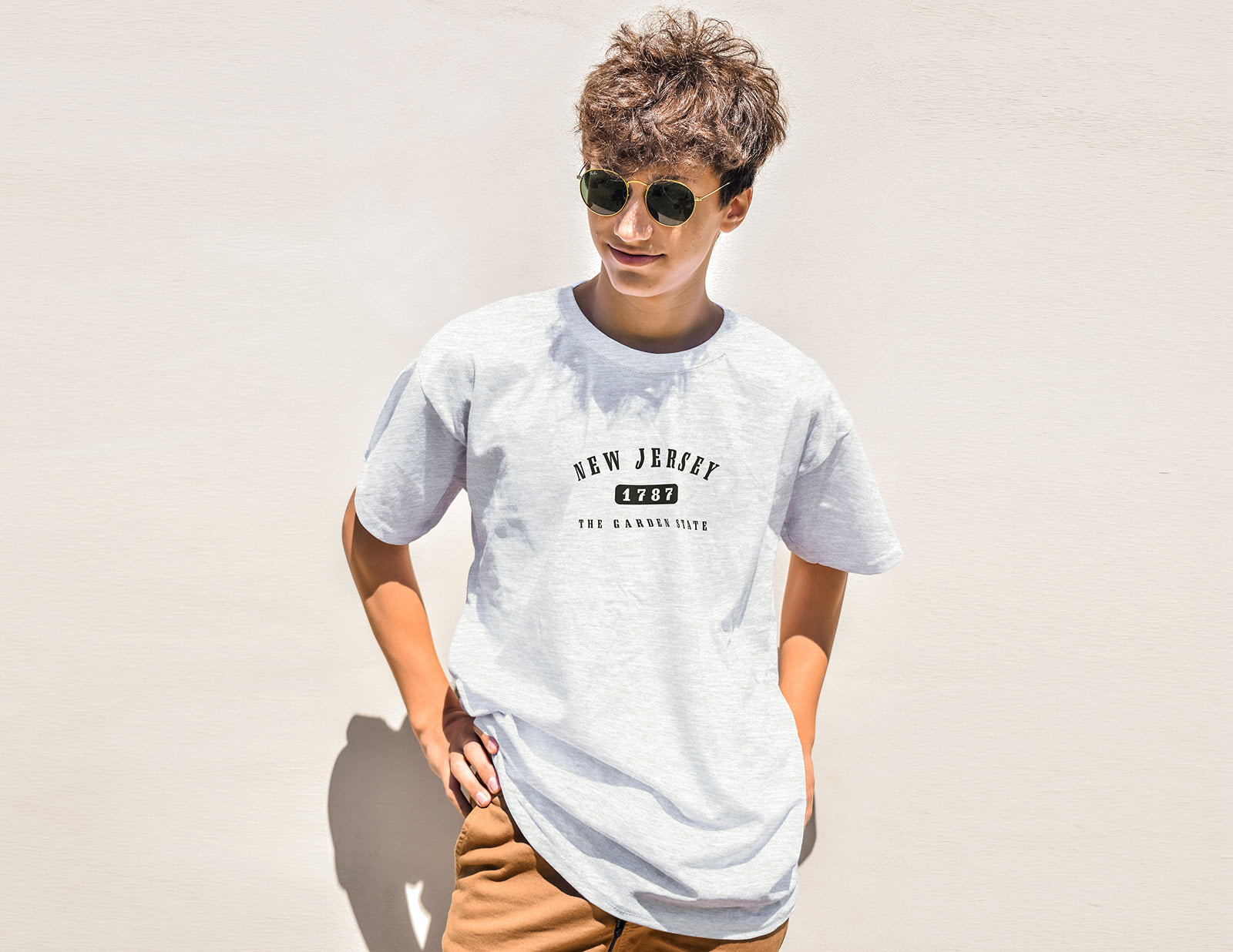 Person wearing a white t-shirt with 'New Jersey 1789' text on a plain background