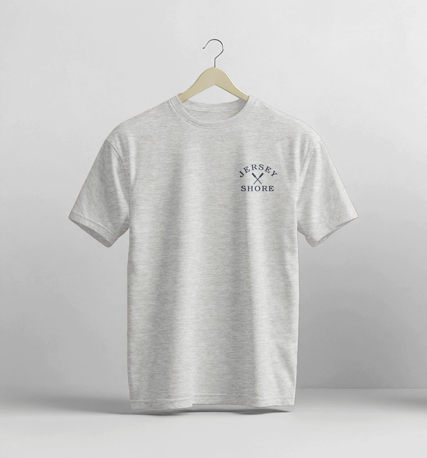 Gray t-shirt with 'Jersey Shore' text on a hanger against a light gray background