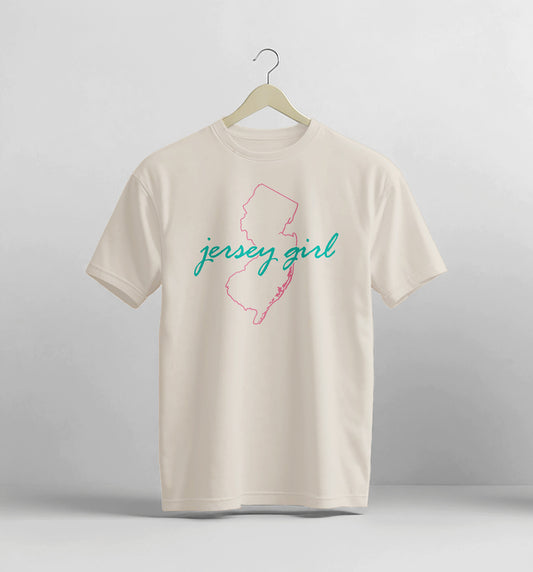Beige t-shirt with 'jersey girl' design on a hanger against a light gray background
