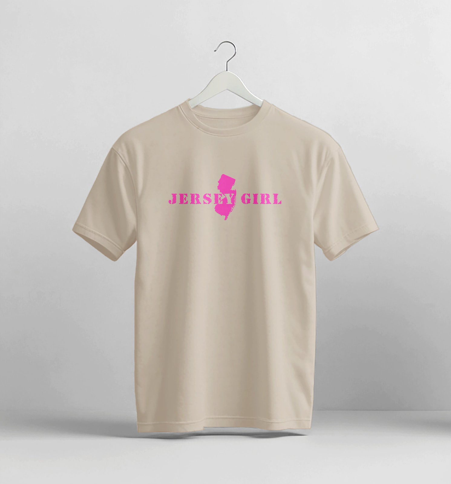 Beige t-shirt with 'Jersey Girl' text and pink graphic on a white background